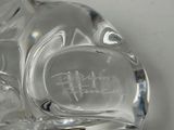 a glass cat figurine sitting on a table