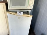 two microwaves stacked on top of each other in the kitchen