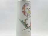 a white vase with a picture of a woman and a bird on it