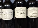 several bottles of wine are lined up on a shelf