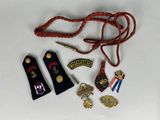 a lot of badges that are laying on a table