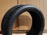 tire on the floor next to a cardboard box with a cardboard box in the background