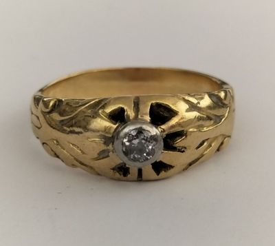 a close up of a gold ring with a diamond in the center