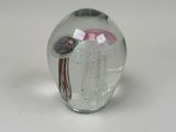 a glass vase with a jelly fish inside of it