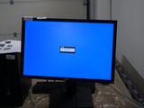 a computer monitor with a blue screen sitting on a desk
