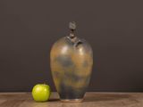 an image of a vase and an apple on a table