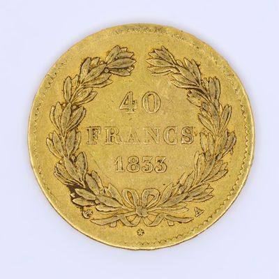 an image of a gold coin with a wreath of leaves on it