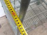 a measuring tape that is on the side of a cage