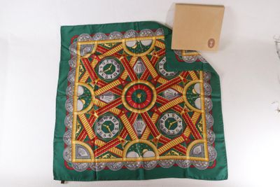 a green table cloth with a red and yellow design on it