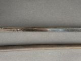 pair of old swords on a table with a metal handle