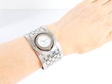 wrist shot of a woman ' s wrist with a watch on it