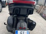 a motorcycle parked in a parking lot with a license plate on it