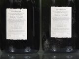four bottles of wine are lined up on a table