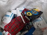 a pile of clothing in a plastic bag on the floor
