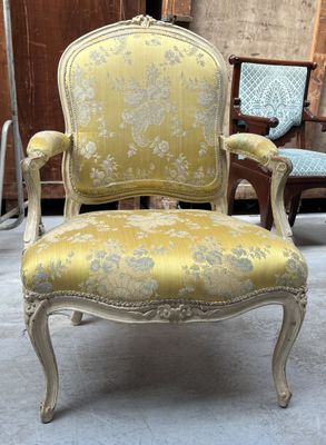 an old chair with a yellow upholstered upholstered upholstered upholstered upholstered