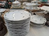 a lot of plates and bowls on the table