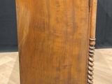 a wooden cabinet with a drawer on top of it on a wooden floor
