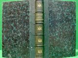 an old book that is sitting on a green table