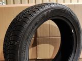 tire on the floor next to cardboard boxes in a warehouse