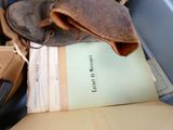 a bag of books and a pair of shoes on a chair