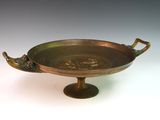 brass plate with handles on pedestal on white background