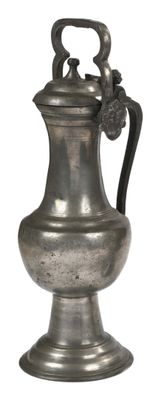 a silver vase with a flower on it on a white background