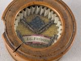 a close up of a small clock on a table