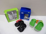 three pairs of shoes and a box on a table