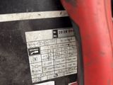 a close up of a red and black corded drill