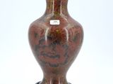 a vase that is sitting on a stand on a white surface