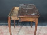 a small wooden table with a marble top on a carpeted floor