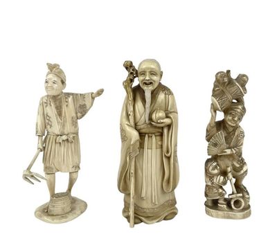 three chinese carved figurines of a man and a woman