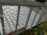 a metal gate that has a sign on it
