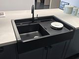 a black sink in the middle of a kitchen counter