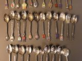 many spoons and spoon spoons hanging on the wall