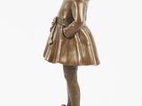 bronze figurine of a little girl with a hat and dress