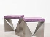 pair of purple and silver stools in a white room