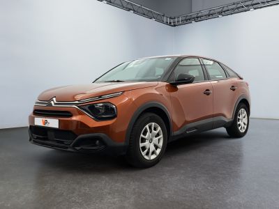 a brown car parked in a room with a white wall