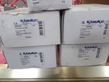 three boxes of kluke are stacked on top of each other