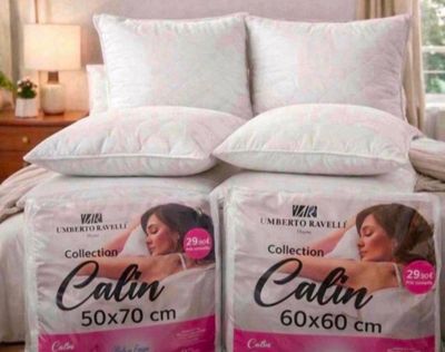 two pillows on the bed with a picture of a woman on it