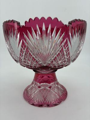 purple glass bowl with a flower design on top of it