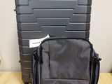 a black suitcase sitting on a wooden table next to a black suitcase