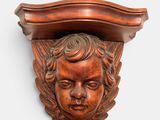 an image of a carved head on a shelf above a shelf