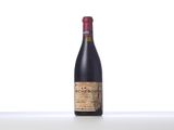 a bottle of red wine sitting on top of a table