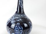a blue and white vase with an umbrella on top of it