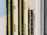 three model trains in a box on the table