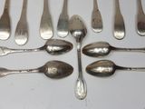 a lot of silver spoons and spoon spoons on a table
