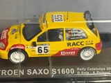 a model of a yellow car in a display case