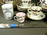 a table with a knife, cups, and saucers on it