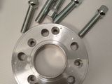 a metal plate with screws and nuts on it